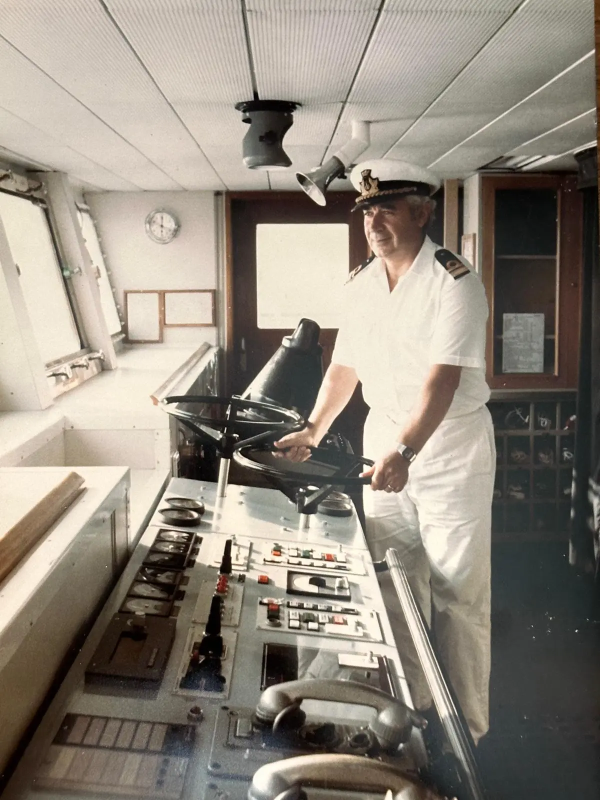 Il Comandante Giovanni Santoro al timone della sua nave, in divisa bianca